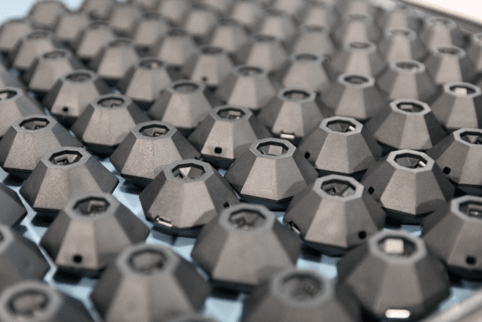A large number of Nix Minis are displayed upside down on a tray